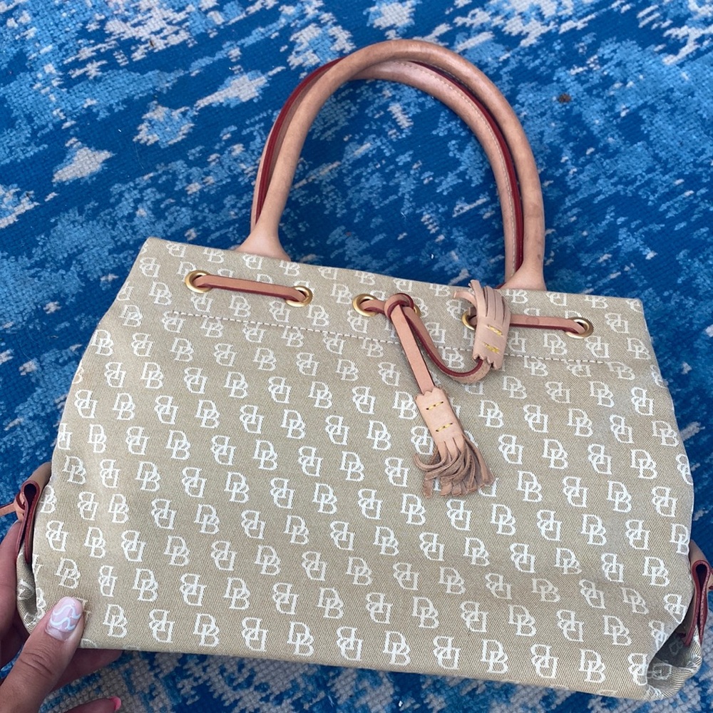 Like new Dooney and Burke, tan handbag. Carried less than 5 times !!